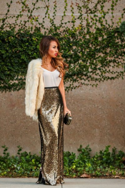 white faux fur coat with tank top and maxi gold sequin skirt