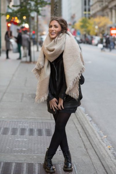 Ivory oversized fringed scarf with black mini dress and leather boots
