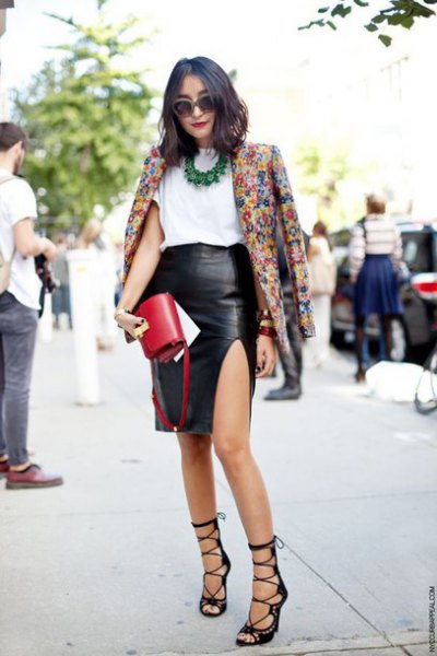 Blazer with floral print and black faux leather skirt with side slits
