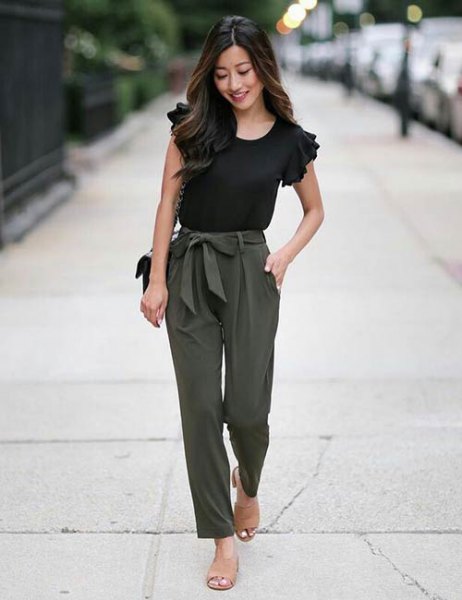 black t-shirt with ruffled sleeves and slim-cut trousers with an army green tie at the front