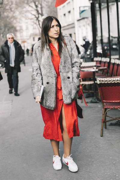 gray faux fur coat with orange midi dress and white hiking tennis shoes
