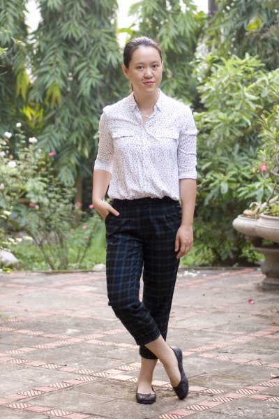 white printed blouse with dark green checked ankle pants