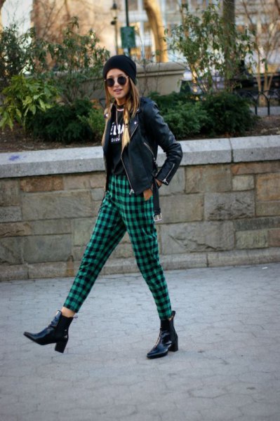 black moto jacket with knitted hat and green, checkered, short-cut trousers