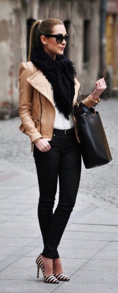 brown leather jacket with white faux fur collar and black jeans