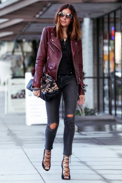 black leather jacket with dark blue, torn skinny jeans