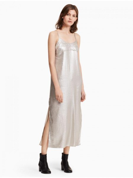 silver maxi dress with spaghetti strap and scoop neck and black leather ankle boots