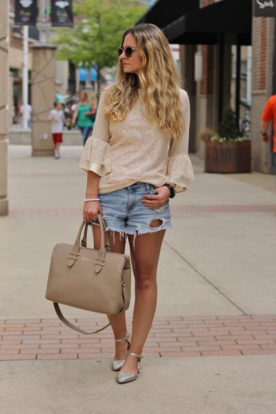 light pink bell-sleeved blouse with blue denim shorts