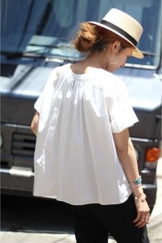 white short sleeve blouse with straw hat and black jeans