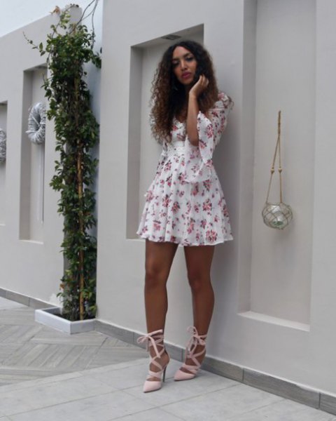 white and blushing mini swing dress with half bell sleeves and pink heels