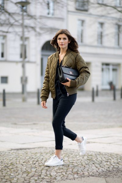 green quilted pilot jacket with black jeans with cuffs and white sneakers
