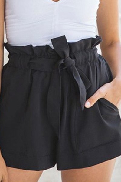sleeveless blouse with white V-neck and black mini shorts