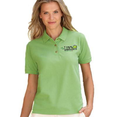 light green embroidered polo shirt with white chinos