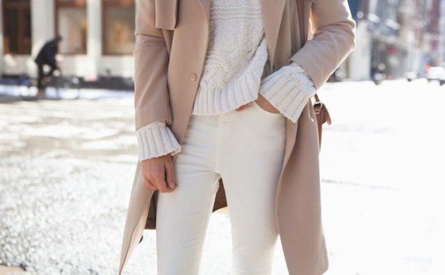Chunky sweater in ivory with a red coat and cream-colored jeans