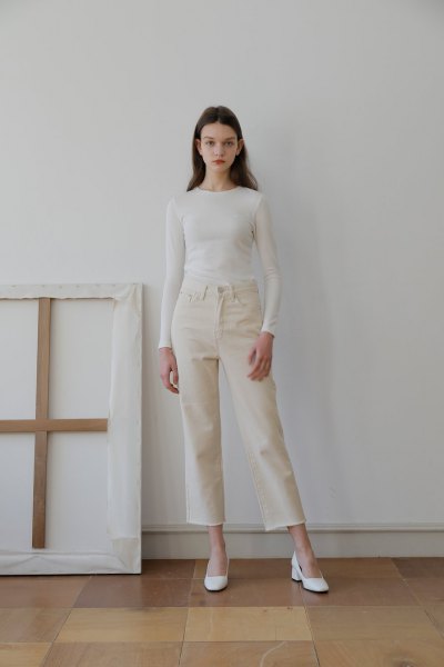 white, form-fitting long-sleeved T-shirt with ivory jeans