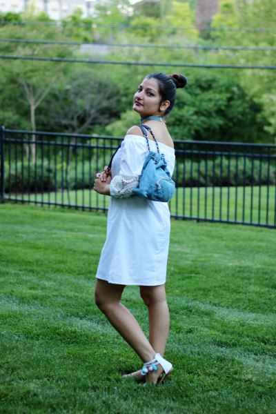 off-the-shoulder white mini blouse dress with light blue denim backpack
