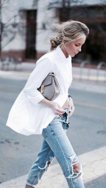 oversized white shirt with buttons and torn light blue knee jeans