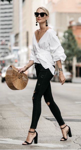 white wrap frill shirt with deep v-neck and black skinny jeans