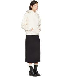 white hoodie with black midi skirt and leather boots