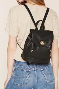 Light pink rib top with black leather, small backpack and jeans