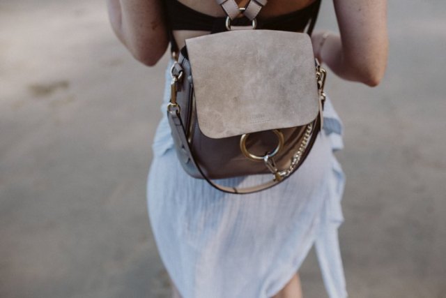 airy mini dress made of white chiffon with gray suede backpack handbag