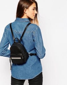 blue chambray shirt with buttons and black small backpack wallet