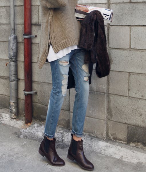 gray side slit sweater with torn jeans and black leather boots with zipper