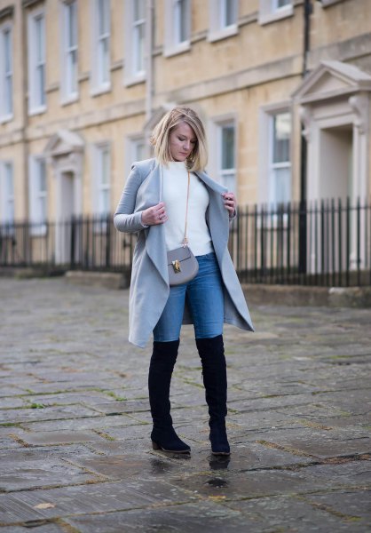 gray longline wool coat with white mock-neck sweater and black high boots