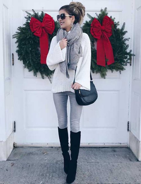 white, knitted sweater with gray skinny jeans and black, knee-high, high boots