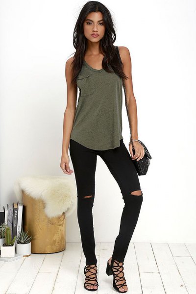Olive green tank top with torn black skinny jeans