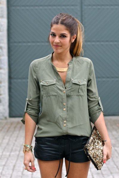 green utility shirt with buttons and black mini leather shorts