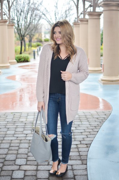 long cardigan with black blouse and torn knee jeans