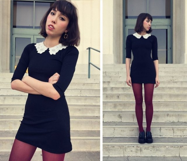 black dress with a scalloped collar and stockings and oxford shoes