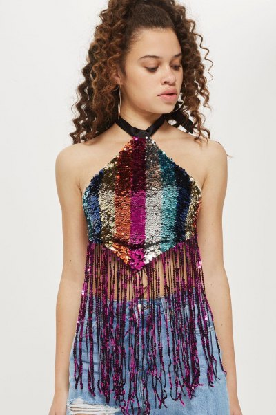 multicolored top with sequin fringes and blue, torn jeans