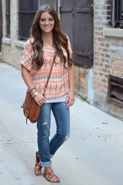 pale yellow top with tribal print and jeans with blue cuffs