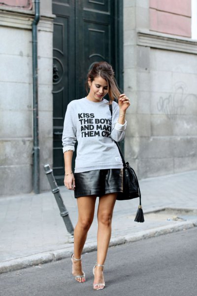 gray graphic sweatshirt with black leather mini skirt