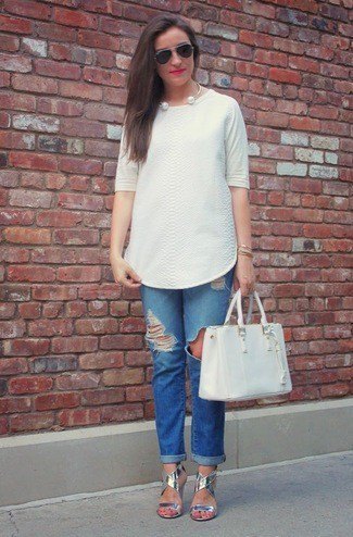 white tunic blouse with blue torn jeans with cuffs and silver sandals