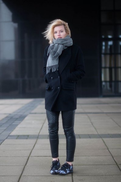 black wool coat with gray fringed scarf and leather pants