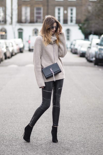 gray, ribbed sweater with a waterfall neckline and black leather pants