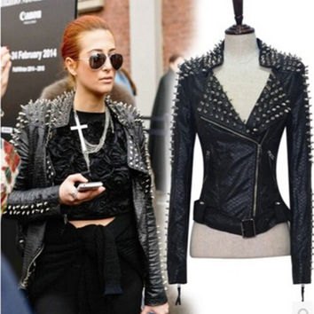 Leather jacket with spikes, crop top and black high-waisted mini skirt