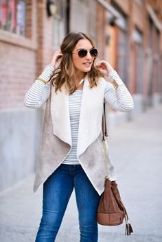 gray and white Sherpa vest with a striped long-sleeved T-shirt