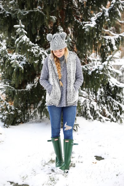 gray sherpa vest with sweater and blue jeans
