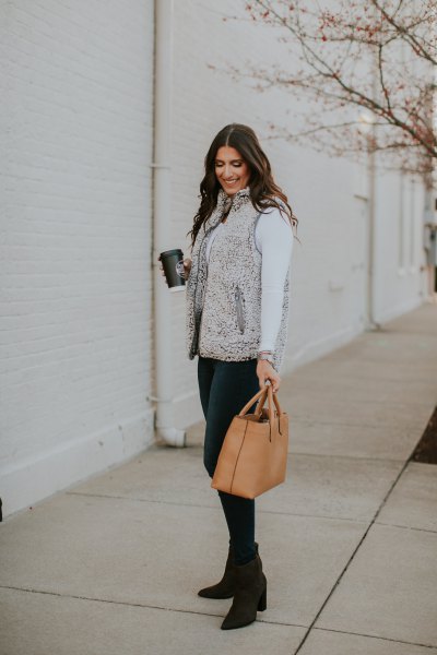 gray sherpa vest with white mock-neck long-sleeved t-shirt