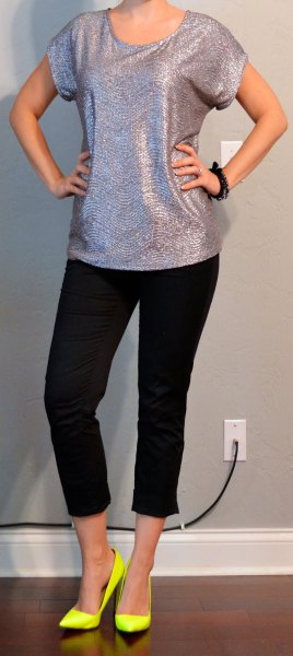 silver t-shirt with a scoop neck, black, short jeans and yellow heels
