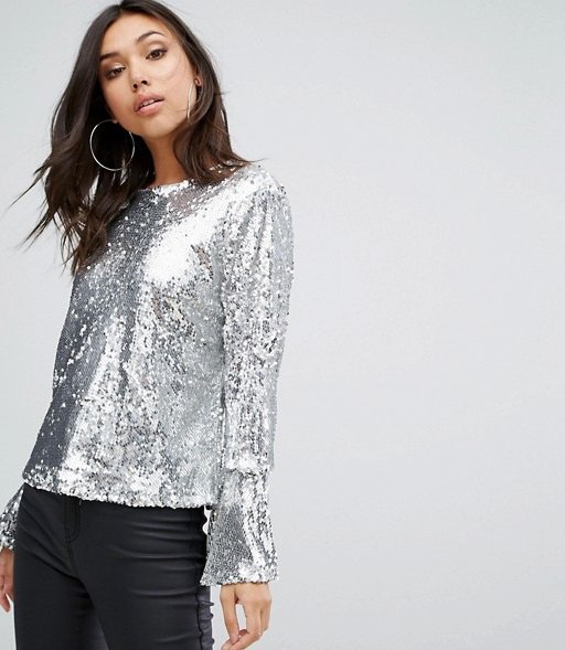 silver sequin top with long bell sleeves and black coated skinny jeans