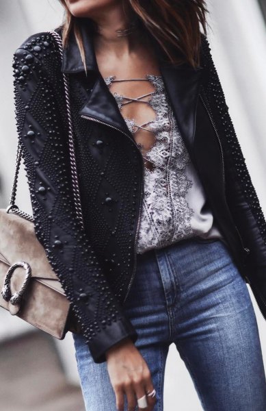 Leather jacket with black rivets and blue jeans