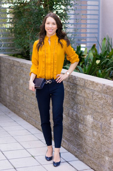 Mustard yellow pleated shirt with buttons and dark blue chinos