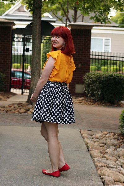 sleeveless blouse in mustard color with black and white dotted skater skirt