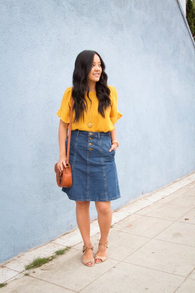 yellow chiffon blouse with short sleeves and blue knee-length denim skirt