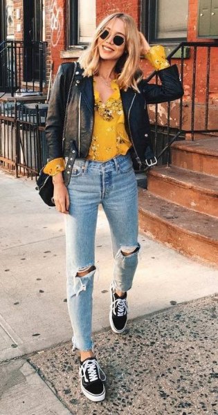Mustard yellow blouse with floral pattern and black leather biker jacket