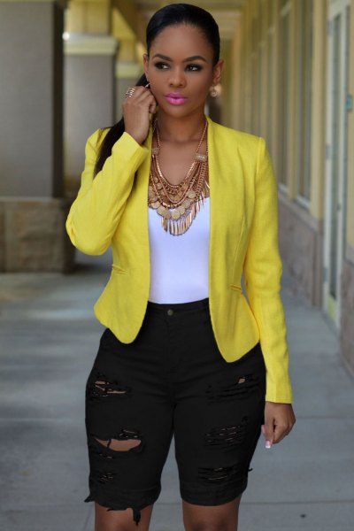 yellow blazer with long, high-waisted shorts made of black denim